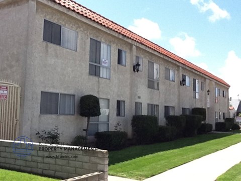 an apartment building with a lawn in front of it